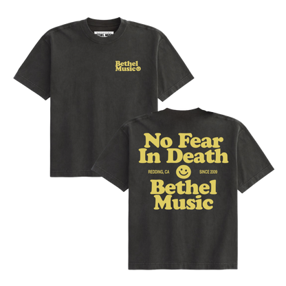 Black t-shirt with yellow text and Bethel logo on a white background